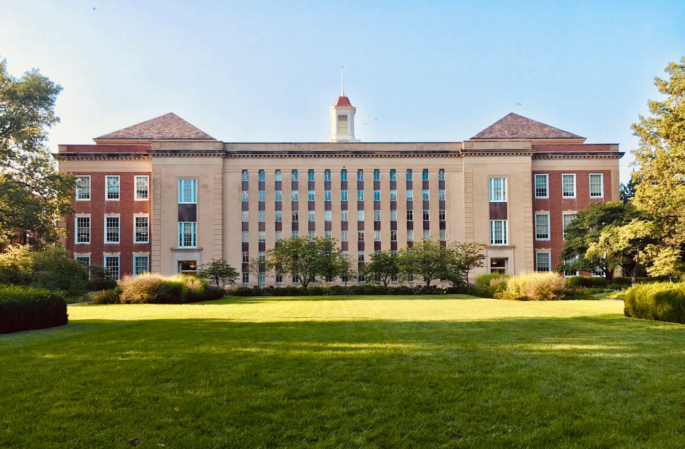 University campus building seen through trees
